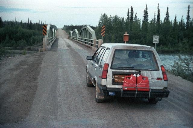 car at bridge that starts the Dempster Highway northbound, Yukon, Canada