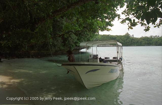 Boat along a beach in the Rock Islands, Palau