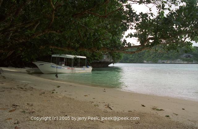 Boat along a beach in the Rock Islands, Palau