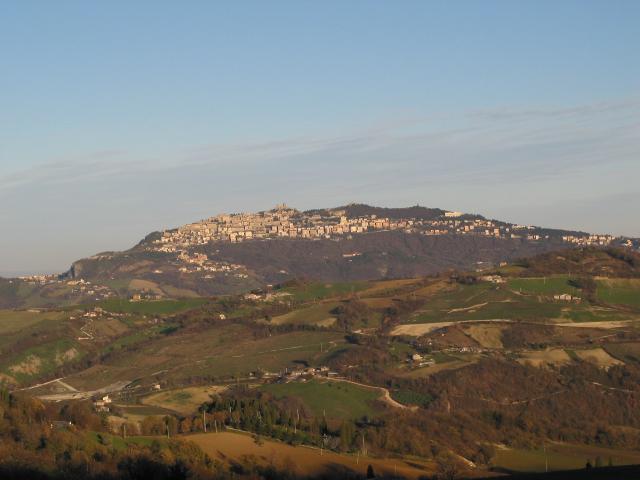 San Marino on a distant hill with hills in foreground