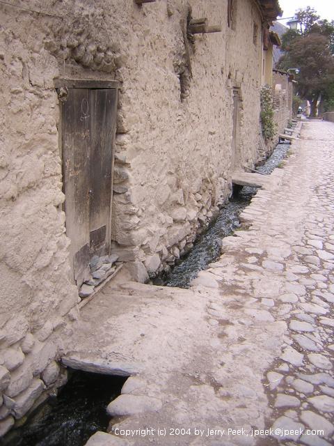 Bridges to building entrances over water channels, Ollantaytambo, Peru