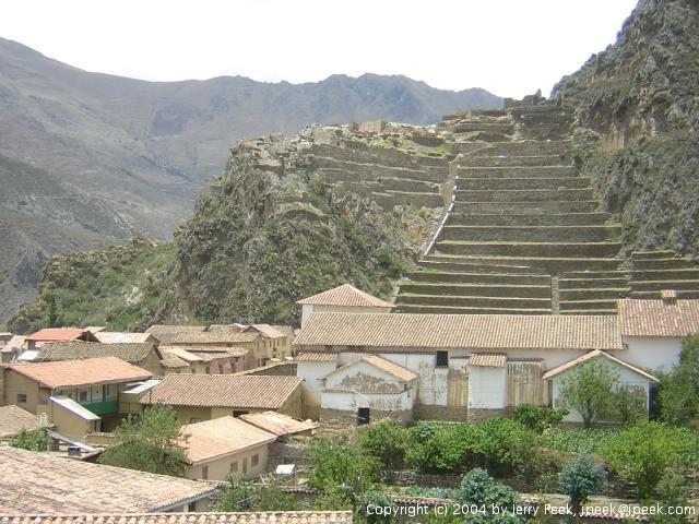 Temple and other ruins with modern buildings in front, Ollantaytambo, Peru
