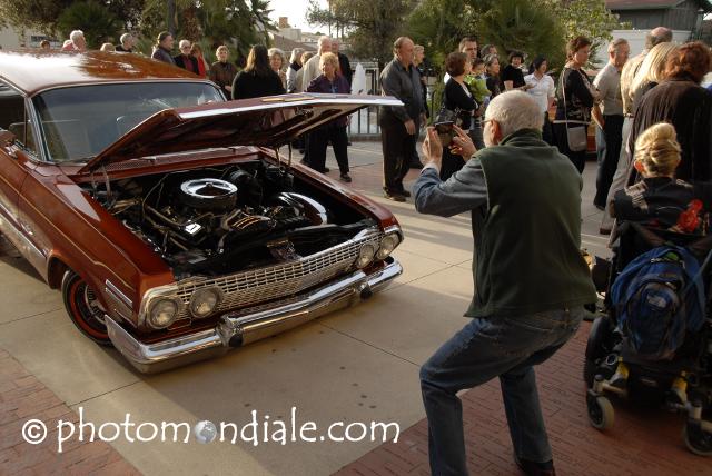 Man photographs engine of low-rider Chevy, Tucson Museum of Art plaza