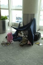 Tent made from airline blankets for children spending the night on the floor of Guayaquil Airport