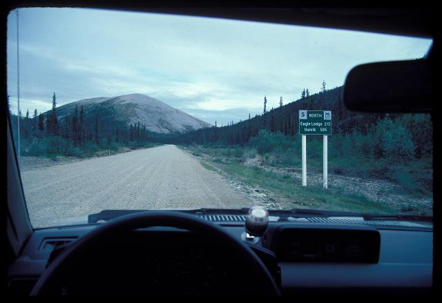 Sign on Dempster Highway (route 5) northbound: distances to Eagle Lodge and Inuvik