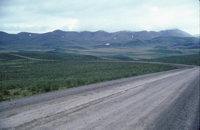 Dempster Highway stretches north toward distant mountains