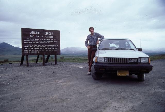 Jerry Peek and Toyota Tercel 4WD wagon at Arctic Circle sign on the Dempster Highway