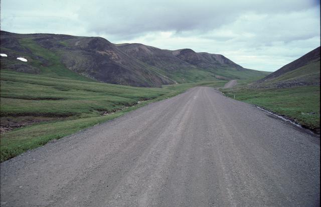 Dempster Highway stretches north past hills