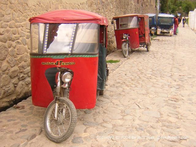 Motorcycle taxis along a street, Ollantaytambo, Peru