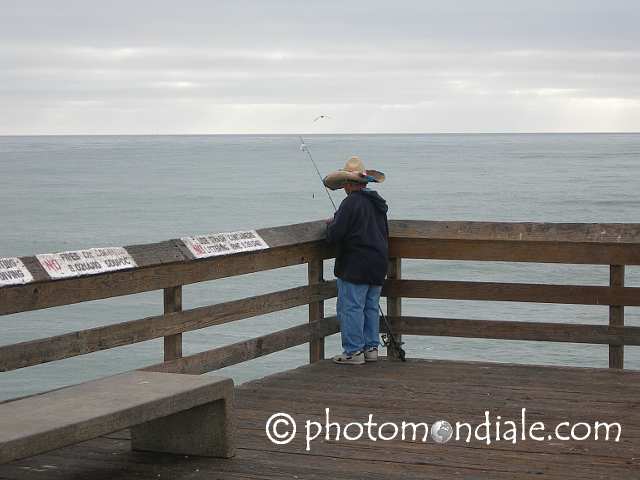 Fisherman wearing sombrero on Imperial Beach pier