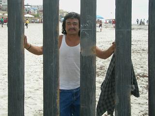 Mexican man through the border fence